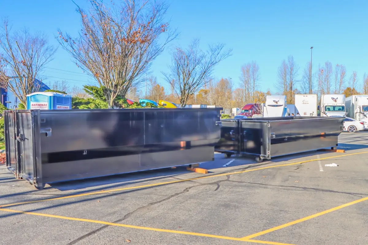 Professional dumpster rental service with roll-off container on residential driveway in Zachary